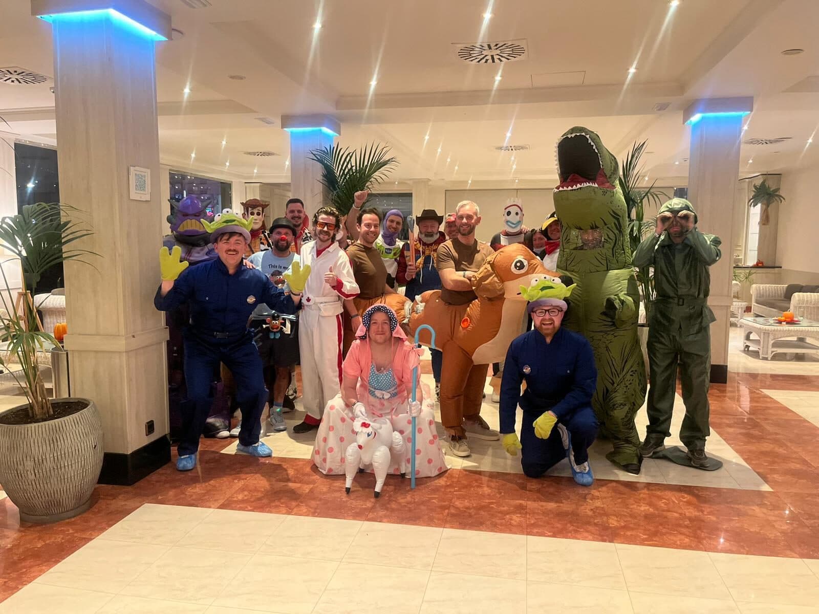 A stag group in Toy Story fancy dress posing in a hotel lobby